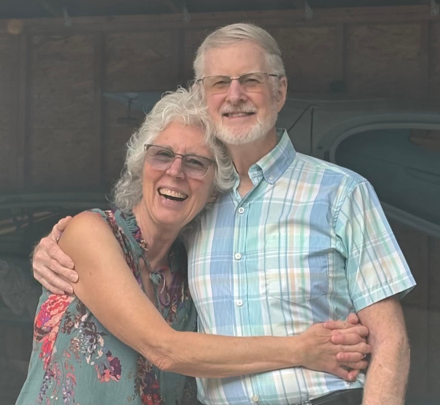 Pamela and Brad standing together, arms around each other