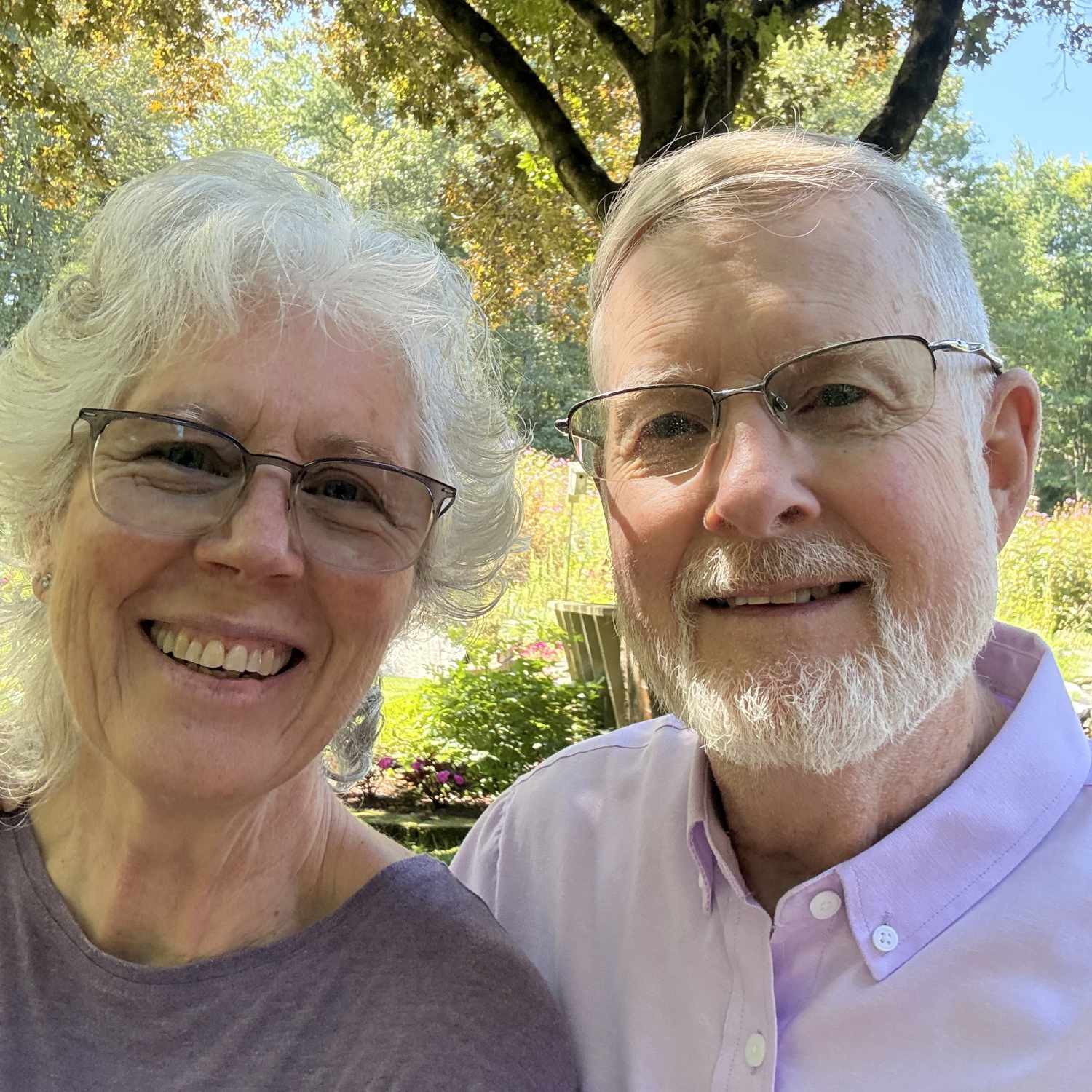 Pamela and Brad, smiling in their garden