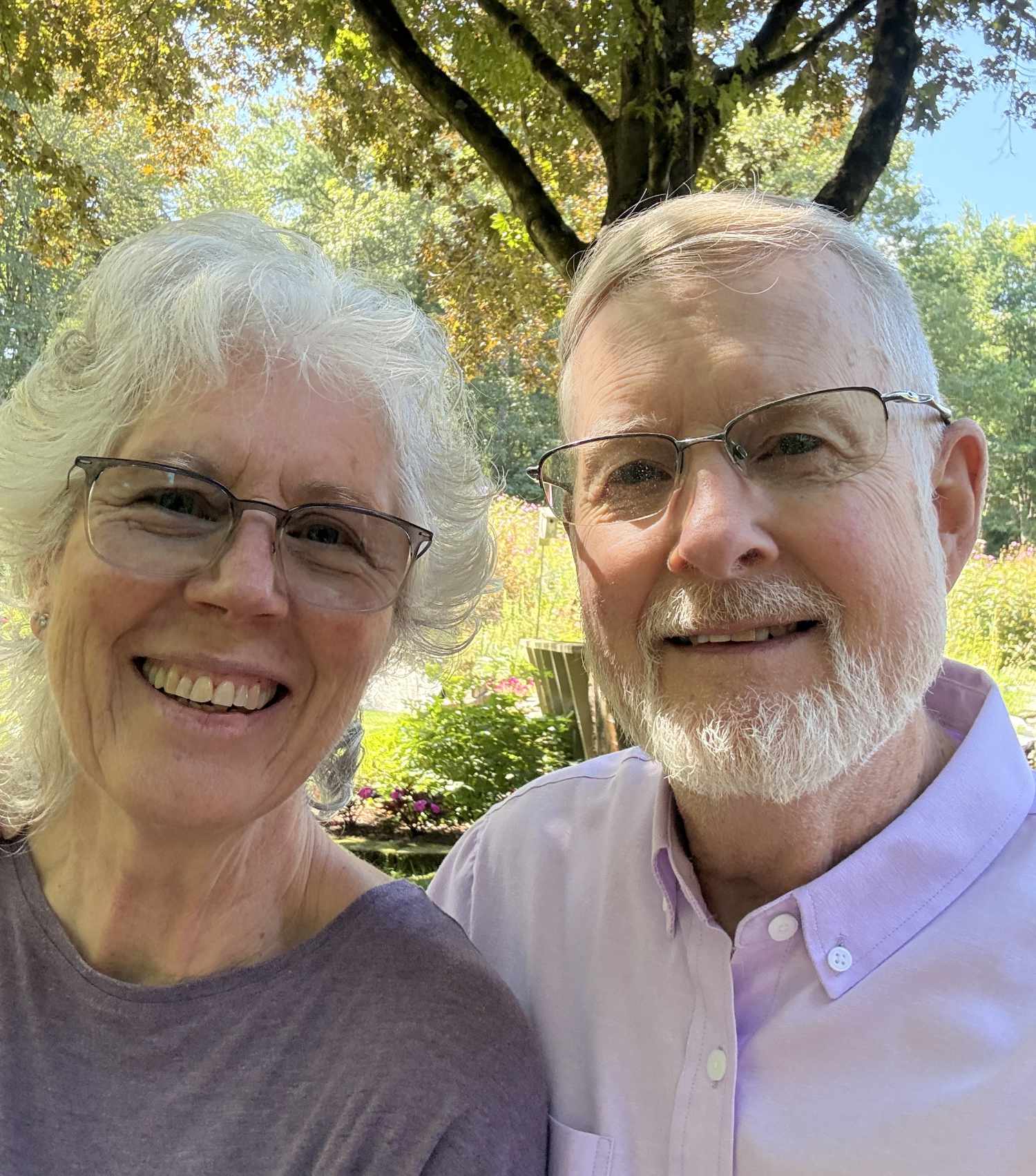 Pamela and Brad, smiling in their garden